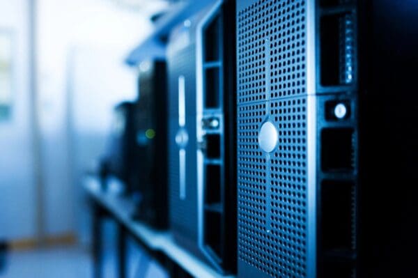 A row of servers in a room with blue lighting.